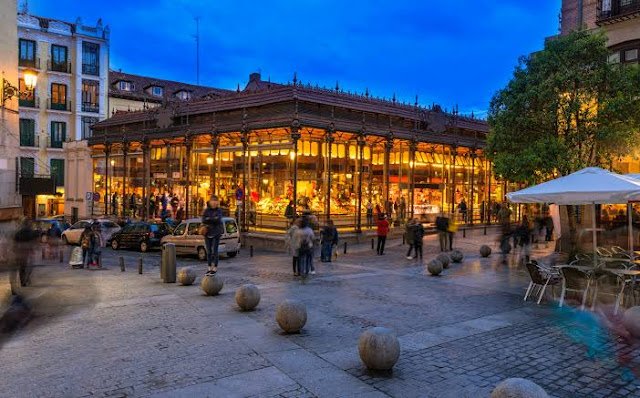 Plaza Mayor Madrid at sunset with cafés and historic buildings