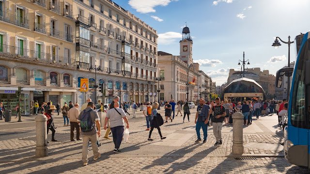 Gran Vía Madrid bustling at night with illuminated theaters