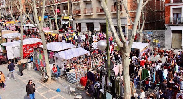 Crowd browsing stalls at El Rastro flea market, Madrid